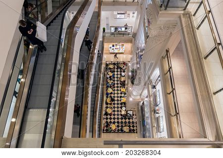 LONDON ENGLAND - JUNE 09 2017: Stairwell with shopping people in famous Selfridges department store London