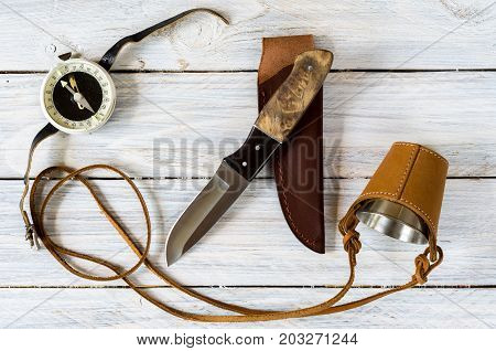 Outdoor Composition With A Knife, Glass And Compass On A White Background.