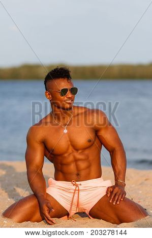 Muscular Young Athletic Sexy Man On The Beach With A Naked Torso