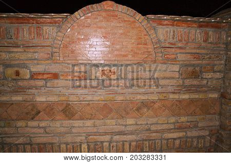 Retro brick wall at dark, close up