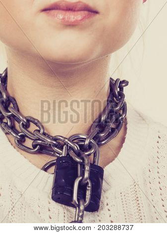 Slavery lack of freedom speech social problems anxiety sore throat no human rights concept. Woman having heavy chain with padlock on neck.
