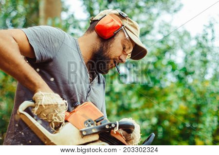 industry building technology and people concept - male builder in hardhat with walkie talkie or radio outdoors