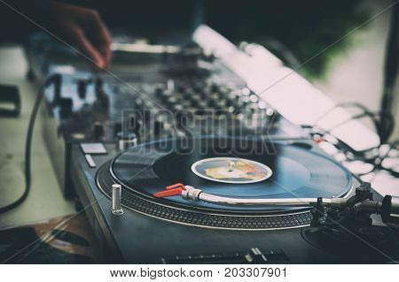 DJ's hands and turntable closeup. selective focus