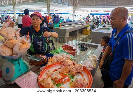 Keningau,Sabah,Malaysia-June 29,2017:Buyer man buy chicken meat in the local market Tamu in Keningau,Sabah.Its a place where all farmers,fishermen & vendors gathers weekly to sell their products