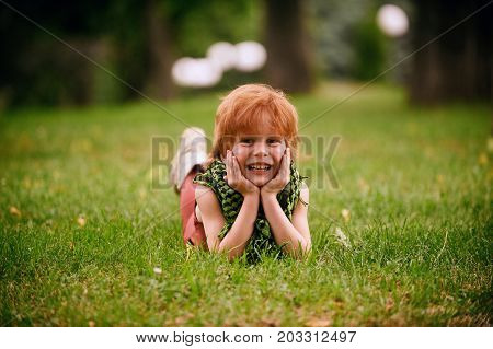 Red head boy playing in the park