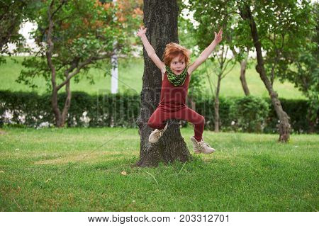 Red head boy playing in the park