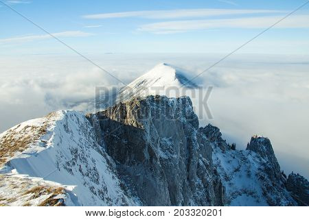 Mountain peak above the clouds. Sunny winter day on mountain above the clouds. Dry mountain in Serbia in winter with highest peak Trem