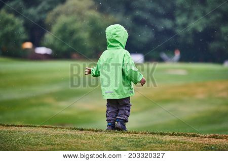 back view of the boy walking the golf course