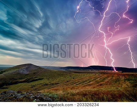 Thunderstorm with lightnings over the fields, long exposure image
