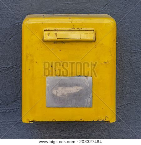 Yellow mail box on the wall postoffice