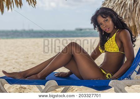 sexy black girl is relaxing on the beach