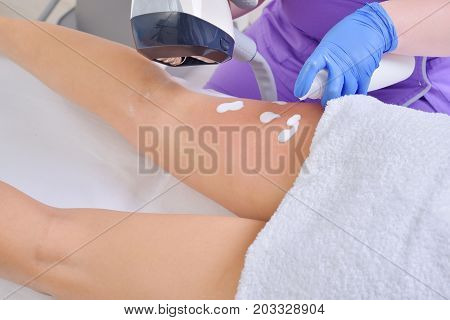 Young beautiful woman gets professional body shape treatment in a beauty clinic