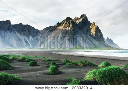 Fantastic west of the mountains and volcanic lava sand dunes on the beach Stokksness, Iceland