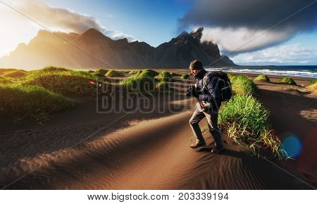 Fantastic west of the mountains and volcanic lava sand dunes to the beach Stokksness. Tourists traveling through the wilderness. Iceland