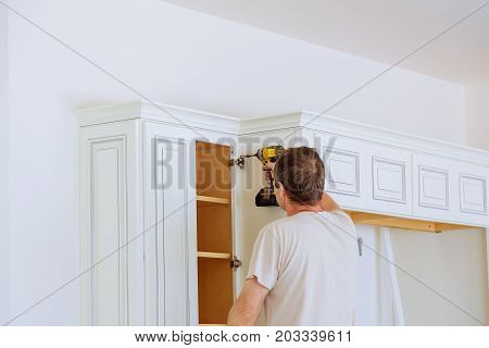 Technician Man Installing Kitchen Cabinets