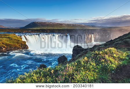 Godafoss waterfall at sunset. Fantastic landscape. Beautiful cumulus clouds. Iceland