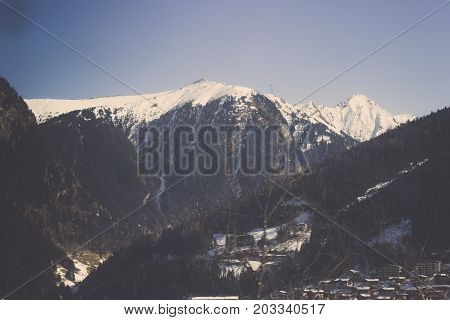 Landscape of Bled town on Lake Bled in the Upper Carniolan region of northwestern Slovenia with sierra and blue sky background, View from Top of mountain to small village surround by mountain range with beautiful peaks covered in snow and forest, Winter v