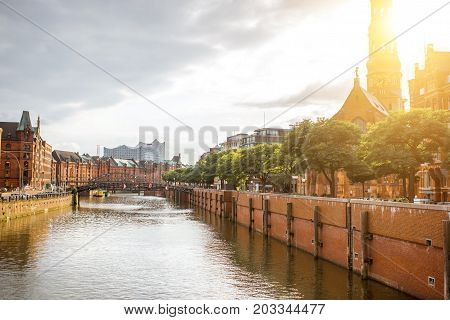 Beautiful cityscape view on the water channel with old church in Hamburg city during the sunset in Germany
