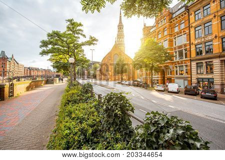 Beautiful cityscape view on the old downtown with saint Catherines church during the sunset in Hamburg city, Germany