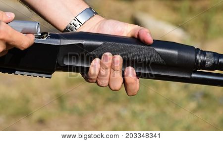 Man loads a shotgun with a patron