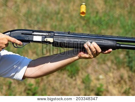 Shooting with a gun outdoor in summer