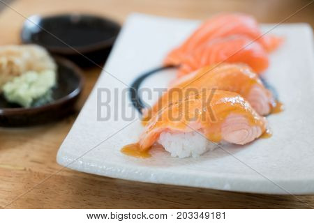 Close up salmon burned top with mayo in plate. Healthy Japanese Nigiri Aburi Sushi style with rice and fish in Japanese food restaurant.