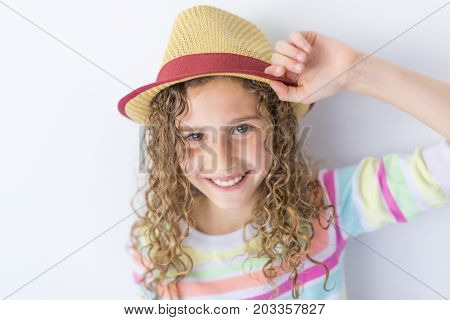 A Portrait of 9 years old girl with curly hair, isolated on gray