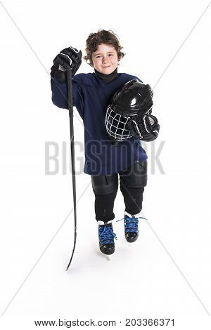 A Young boy in ice hockey gear against white
