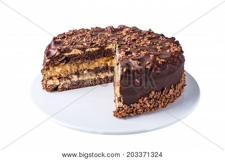 Isolated Chocolate Layered Cake With Nougat And Sponge Cake In The Cut On The Plate