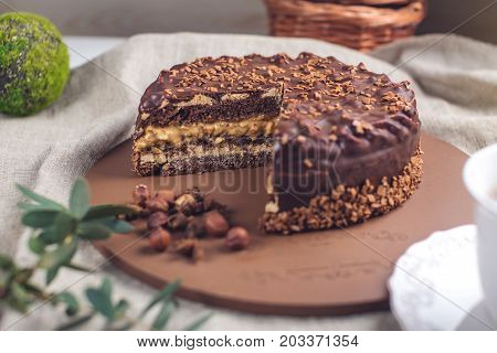 Chocolate Layered Cake With Nougat And Sponge Cake In The Cut On The Plate