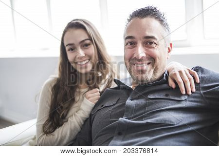 A nice and cool Teenager girl sitting on window with father