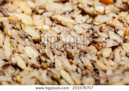 Food textures and patterns concept. Detailed closeup of whole grain bread with many big grains