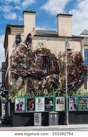 Dublin Ireland - August 7 2017: Art Work on facade of The Workshop Gastro pub off Butt Bridge shows giant squirrel made of recuperated metal rusted metal pieces. Event posters line on wall at street level.
