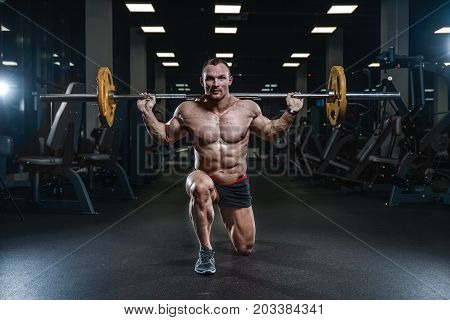 Handsome Model Young Man Training Legs In Gym