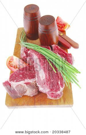 meat portion: bloody beef fillet on plate with cutlery served before cooking