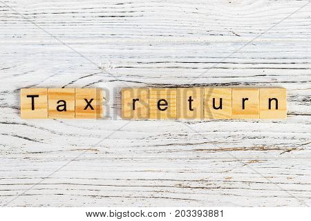 tax return word made with wooden blocks concept