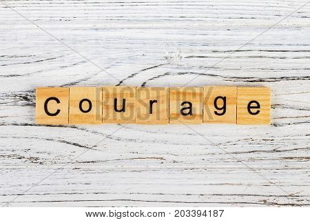 COURAGE word made with wooden blocks concept