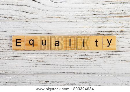 EQUALITY word made with wooden blocks concept