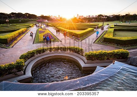 Curitiba, Brazil - July 21, 2017: People walk in the famous park of Botanical Garden during sunset. The garden was opened in 1991 and covers 240.000 m2 in area.