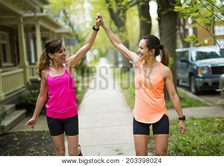 Two Beautiful Female runner outside having fun