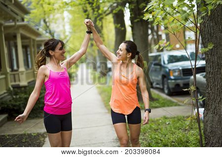 Two Beautiful Female runner outside having fun