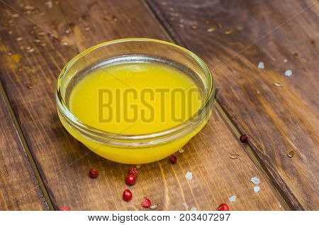 Sauce in a glass bowl on a background of a board