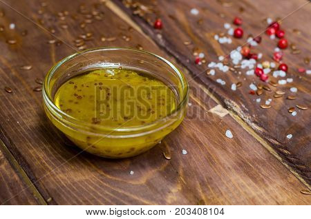 Sauce in a glass bowl on a background of a board