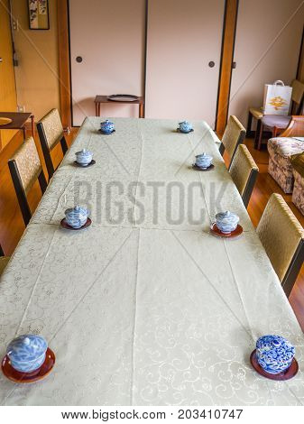 KYOTO, JAPAN - JULY 05, 2017: Indoor view of a table with some tea cups served, inside of a building, in Kyoto, Japan.
