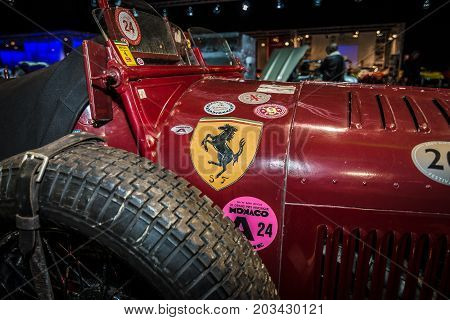 MAASTRICHT NETHERLANDS - JANUARY 08 2015: Fragment of a race car ex-Scuderia Ferrari Alfa Romeo 8C 2300 Monza. Stylization. Toning. International Exhibition InterClassics & Topmobiel 2015