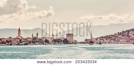 Panoramic photo of the old town Trogir and Ciovo island with harbor. Summer vacation. Travel destination. Red photo filter.