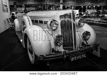 MAASTRICHT NETHERLANDS - JANUARY 08 2015: Oldtimer Packard 120 Convertible Sedan with Dietrich Body 1937. Black and white. International Exhibition InterClassics & Topmobiel 2015