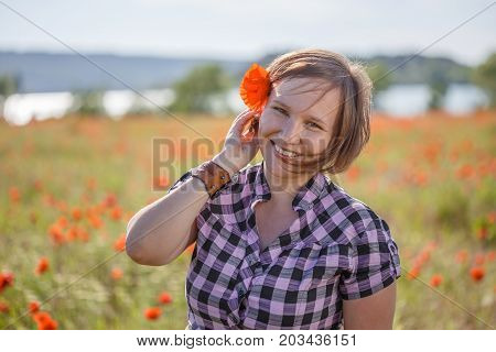 Smiling Woman With Poppy Flower In Her Hair
