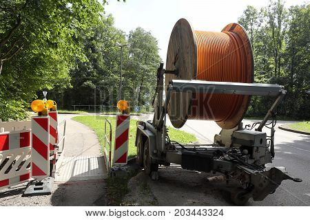 big cable drum near the street with broadband cable