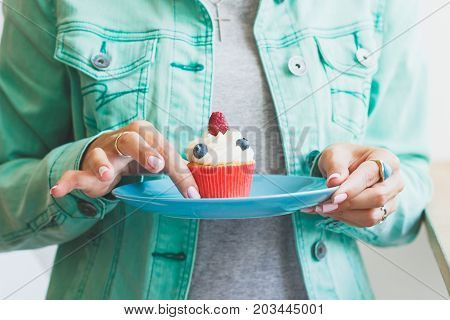Woman With A Cupcake On The Palte